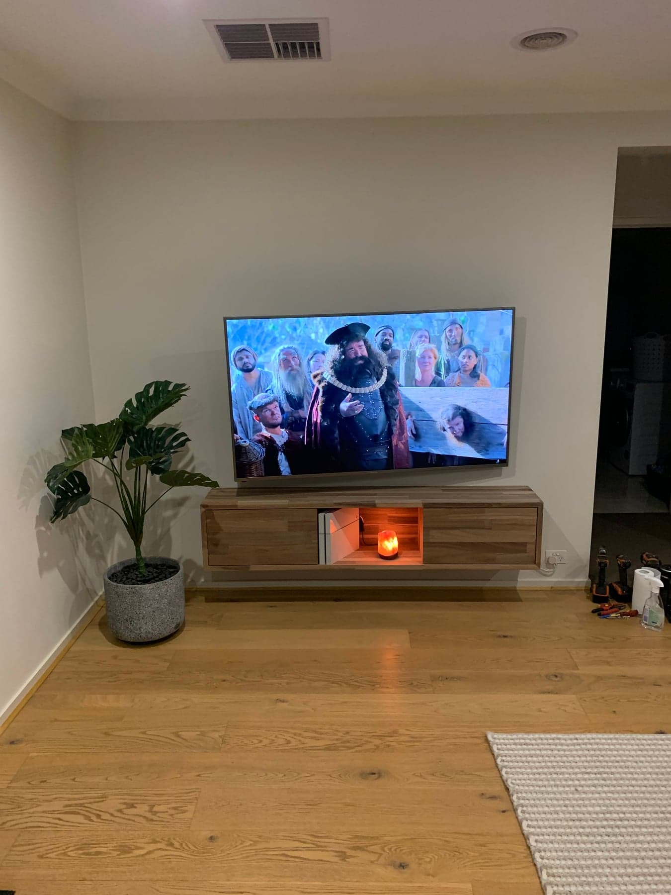 A custom floating timber entertainment unit installed in a living room